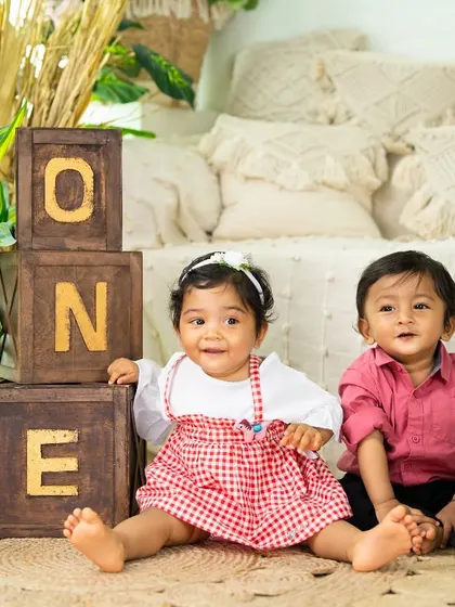 Another adorable shot of these two friends or siblings enjoying their joint birthday celebration in the studio.
