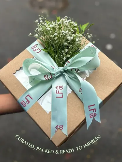 Curated, packed, and ready to impress. This image shows a custom gift box beautifully wrapped with a branded ribbon and fresh baby's breath, highlighting the personal and elegant touch I add to every order.