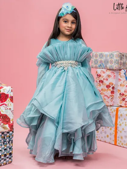 The Alice Blue gown is a vision of elegance with its layered organza skirt and embellished belt.