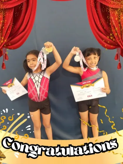 Two of our little champions proudly holding up their medals. Their smiles show the pure joy of achievement that comes from dedication and practice.
