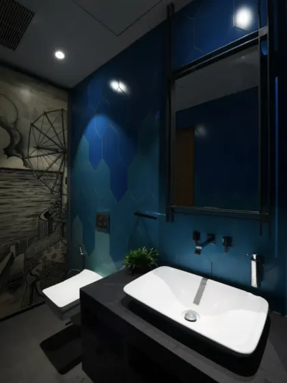This bathroom in the Screen House makes a bold statement with a striking blue accent wall and black-and-white sketch art wallpaper. The white fittings contrast sharply against the black vanity, creating a visually dynamic space.