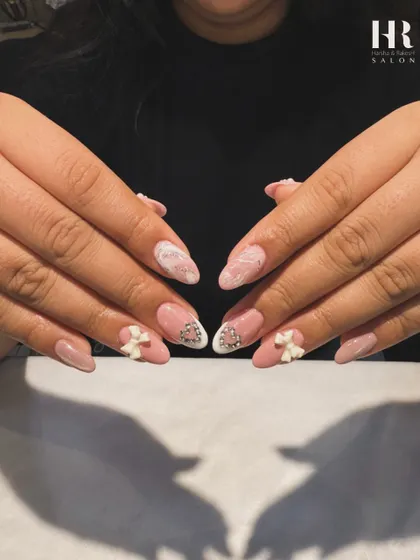 This angle showcases the full set, balancing the detailed 3D accent nails with the softer pink marble nails for a cohesive and beautifully crafted design.