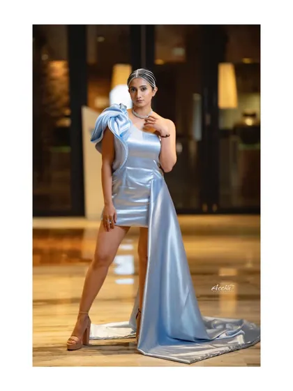 This full-length shot shows off the dramatic, asymmetrical design of the dress. It's a perfect example of how I capture bold fashion choices for red carpet events.