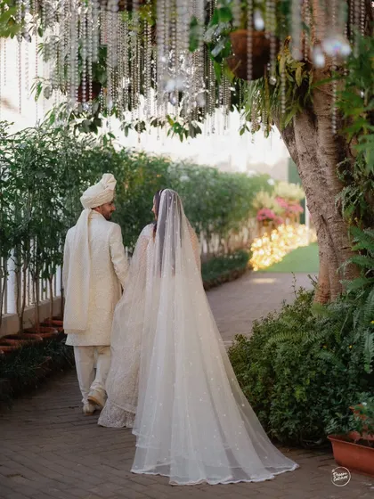 The couple walking away hand-in-hand after their ceremony at Gallops, Mumbai. A beautiful, symbolic shot of them starting their new journey together.