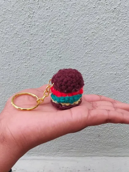 A burger that doesn't make you fat! This tiny crochet burger keychain is a fun and quirky accessory for any foodie.