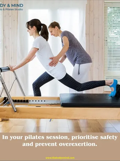 Safety is my priority. Here, I am providing hands on guidance to ensure proper form and prevent overexertion during a Reformer lunge.
