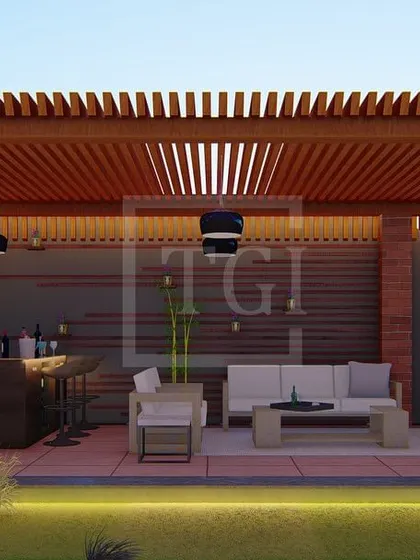 Another view of the covered lounge in the Gurgaon project, showing the bar setup and ample seating for entertaining guests.