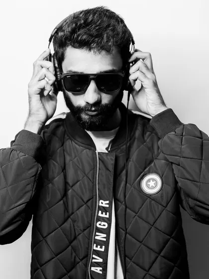 A black and white portrait from my press kit shoot. Just me and my headphones, ready to make people move.