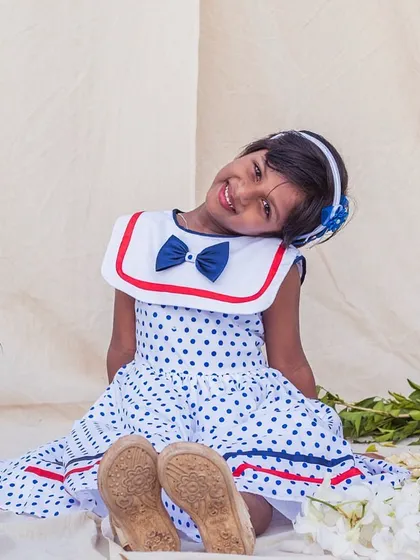A relaxed and happy smile in this comfortable polka dot dress. It's the perfect outfit for feeling pretty and playful during summer playdates.