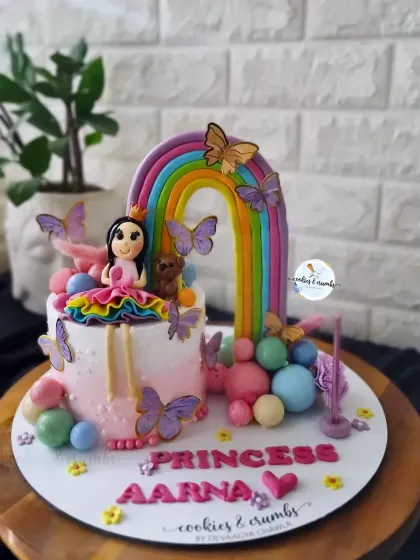 This princess and rainbow cake is packed with detail, from the fondant princess to the colorful spheres and butterflies. It's a perfect example of a small cake that makes a big impact.