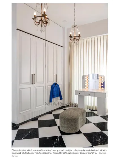 The walk-in closet for the Mumbai home, featuring classic black-and-white checkered flooring and elegant white wardrobes. The space is glamorous and timeless, a perfect reflection of the stylish client.