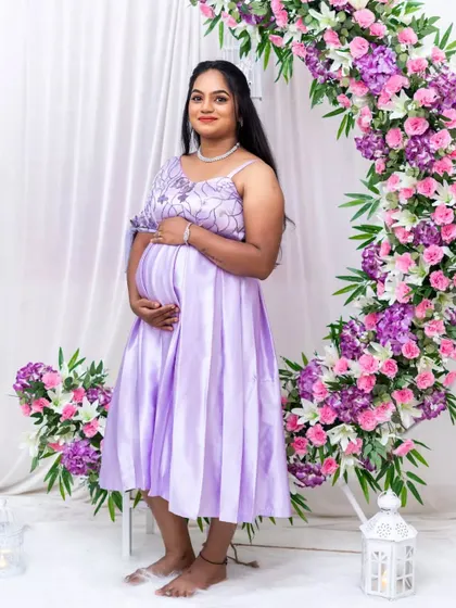A soft and pretty lavender maternity dress, perfect for a serene and gentle photoshoot theme.