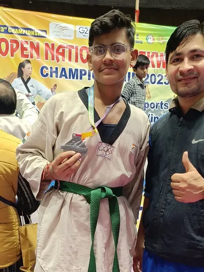 A student proudly shows his silver medal after a tough competition at the national level.