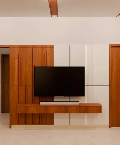 This view highlights the integrated TV unit and door frames, all finished in the same warm wood. This consistency in materials helps to create a harmonious and well-designed space.