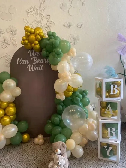 A closer look at the teddy bear themed baby shower decor, with a custom backdrop and "BABY" blocks.