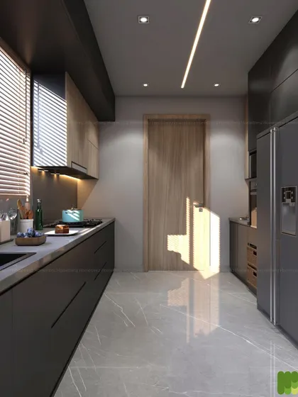 A galley kitchen layout designed to maximize space and efficiency. The dark, handle-less cabinets and integrated refrigerator create a sleek, uniform look, while natural light from the window brightens the space.
