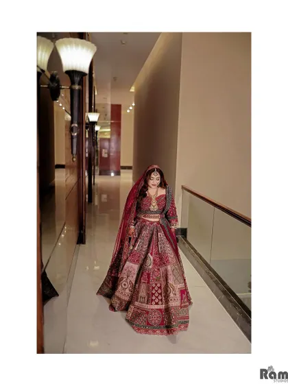 A full-length shot of the bride walking down a hotel corridor, her unique patchwork lehenga on full display.