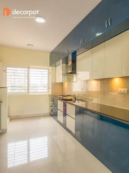 A vibrant parallel kitchen with high-gloss blue and white cabinets. This layout is perfect for long, narrow rooms, providing an efficient and stylish workspace.