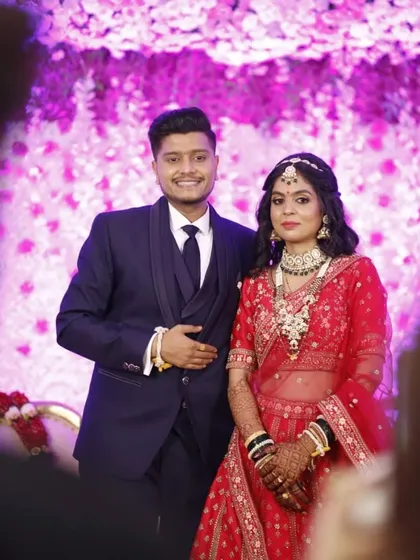 A beautiful couple on their wedding day. Her red lehenga and intricate jewellery are paired with a soft glam makeup look that makes her skin look absolutely luminous.