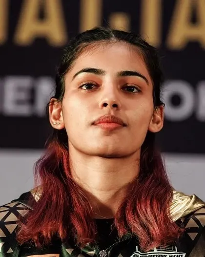 The focused gaze of a fighter. A portrait of Raj Sahiba, mentally preparing for her championship bout.