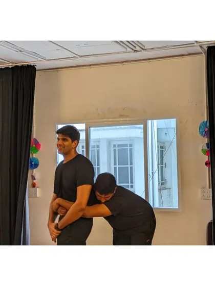 Trust and support are fundamental in partner work. Here, two students practice a supportive hold, a common exercise in our contemporary classes.