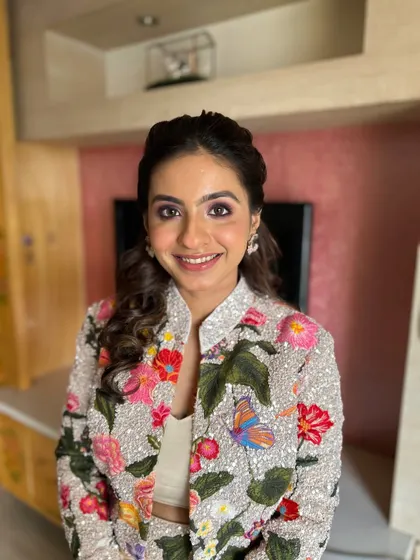 A bright and fresh look for this client in a floral jacket. The makeup is kept clean with a pop of pink on the eyes to match the outfit.