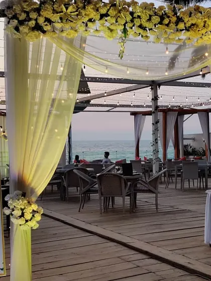 The entrance to the engagement party, featuring a personalized welcome sign and elegant yellow drapes. The decor sets a warm and inviting tone from the moment guests arrive.