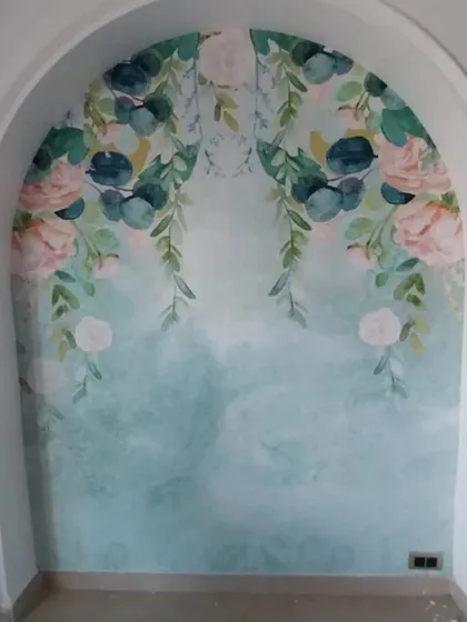 A soft, watercolor-style floral wallpaper in an arched niche, creating a delicate and artistic touch.