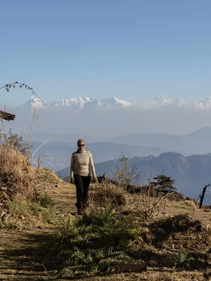A guest enjoying a mindful walk with the Himalayas in the background. My retreats encourage you to explore and connect with the stunning natural surroundings.