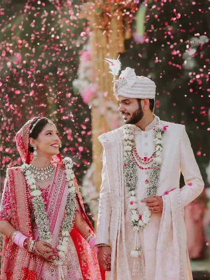 A beautiful candid photograph of the couple walking together after their ceremony, showered in confetti.