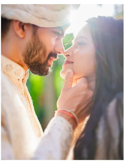 A sun-kissed, romantic close-up of the couple, their faces close together. The natural light and their gentle expressions create a beautiful, dreamy portrait.