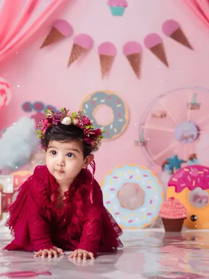 A solo portrait of one of the twins in our colorful Candy Land setup, looking absolutely precious in her floral crown.