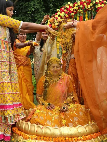 A beautiful moment from a Haldi ceremony, capturing the traditions and blessings from family.