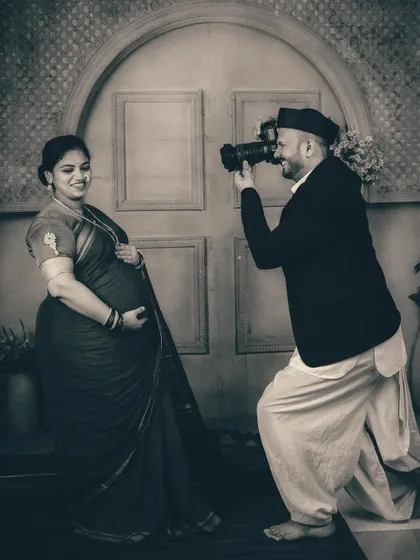 The playful energy of this moment is captured beautifully in monochrome. The black and white treatment gives this fun, candid shot a classic, storytelling feel within the vintage studio series.