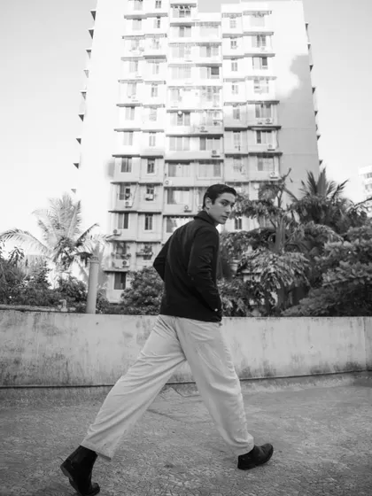 A dynamic, wide-angle shot in an urban setting. This black and white image has a raw, documentary feel, great for a lifestyle or fashion editorial.