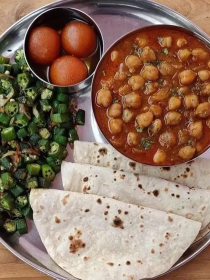 A simple and satisfying meal of Chole, Bhindi Fry, and Gulab Jamun served with soft rotis. It’s a perfect combination of flavors, from savory and spicy to sweet.