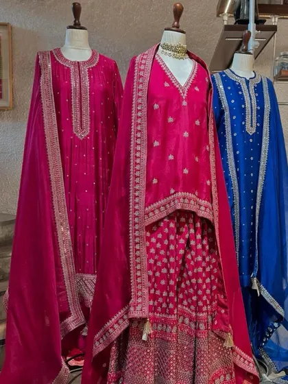 A vibrant collection of suits in fuchsia and royal blue. The intricate silver embroidery provides a beautiful contrast against the bright colors.