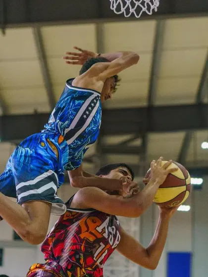 A player leaps over a defender for a shot, a moment of pure athletic artistry captured during our anniversary game.