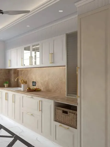 This view of the luxurious off-white kitchen shows a tall pantry unit and a dedicated space for wicker basket storage, blending classic aesthetics with practical, modern solutions.