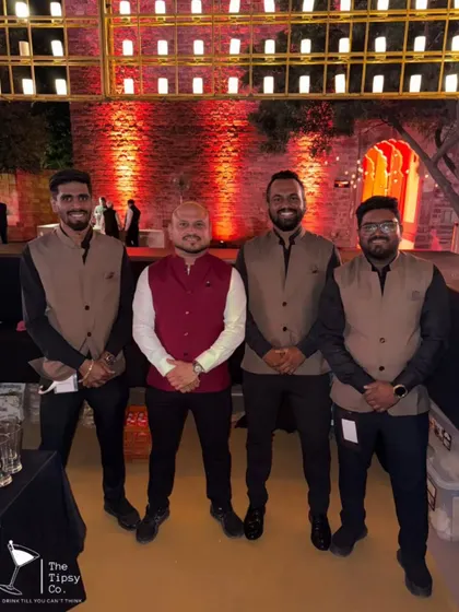 Our team posing with our founder Sid at a grand wedding. We are a close-knit team that pours passion into every event we do together.