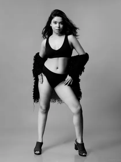 A full-body black and white shot of the same look, showcasing a powerful stance. This is a great example of a classic portfolio image for a lingerie model.
