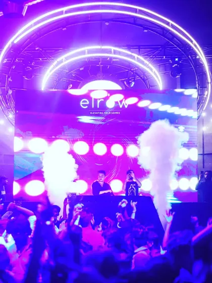 Playing at the Elrow festival in Pune. This shot shows the scale of the production with massive LED screens and smoke cannons, creating an immersive experience for a huge crowd.