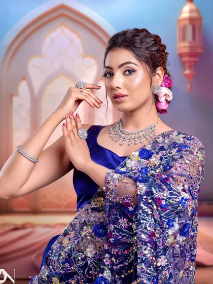 A full shot of the model in the blue saree. The simple CZ necklace is the perfect accessory for this heavily embellished outfit, adding sparkle without being overwhelming.