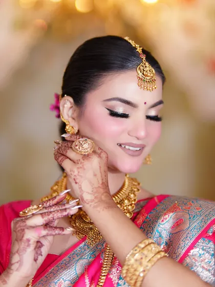 A soft, smiling portrait. The makeup is kept timeless with a neutral brown lip and a hint of blush.