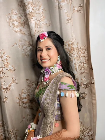 My beautiful bride Ritika, adorned in fresh floral jewellery for her Haldi ceremony. The makeup is kept light and dewy to match the fresh, natural theme.