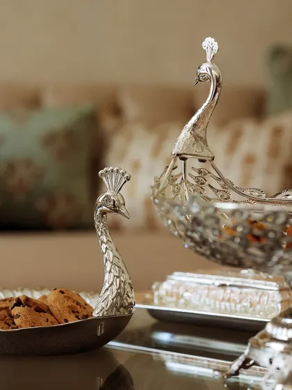 Grace your table with regal elegance. This close-up of my peacock-shaped silver serving trays from the Mijaaz collection highlights the intricate craftsmanship that elevates your hosting moments.