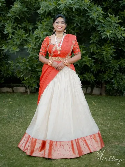 Radiant and glowing! My cherished client Harshitha dazzles on her engagement day in this custom-made red and ivory half saree that I crafted for her in under a week. She looks absolutely stunning.