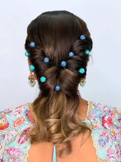 A modern hairstyle featuring custom-made blue beaded hairpins, adding a pop of color and sparkle to the look.