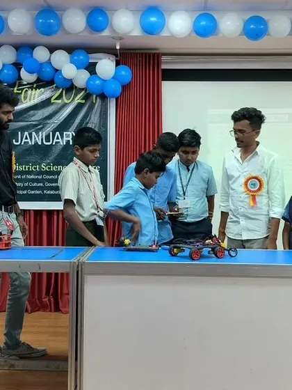A group of curious students gets a close-up look at the robots on display at our Innovation Fair booth. Hands-on exploration is the best way to learn.