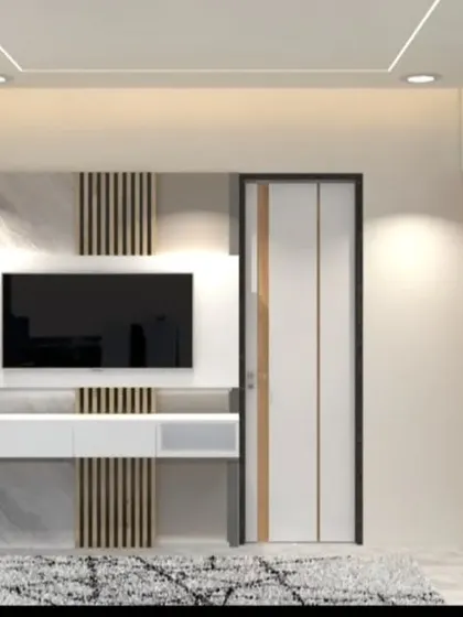 The TV wall in the same bedroom, featuring a simple floating console and a minimalist design.